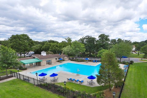 an aerial view of a swimming pool with umbrellas