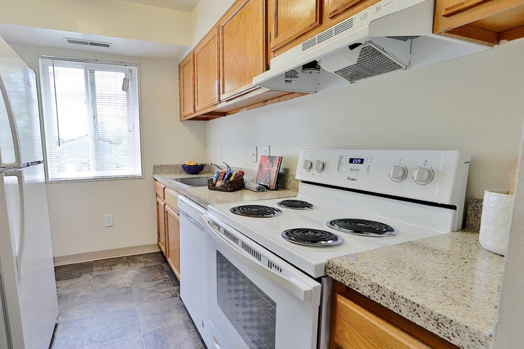 a kitchen with a stove and a refrigerator