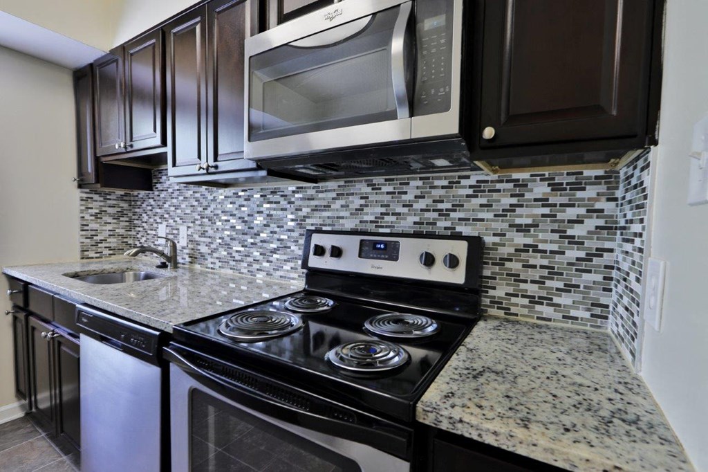 a kitchen with stainless steel appliances and granite counter tops