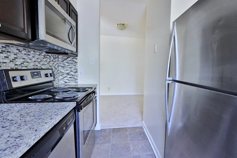 a kitchen with stainless steel appliances and granite counter tops