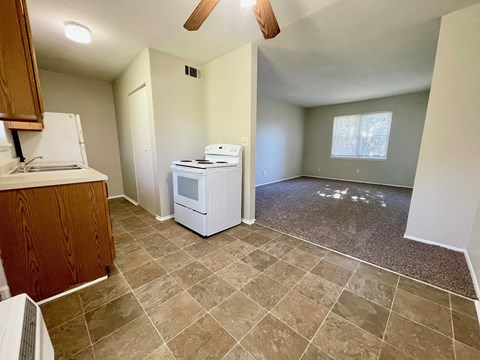an empty kitchen with a washer and dryer in it