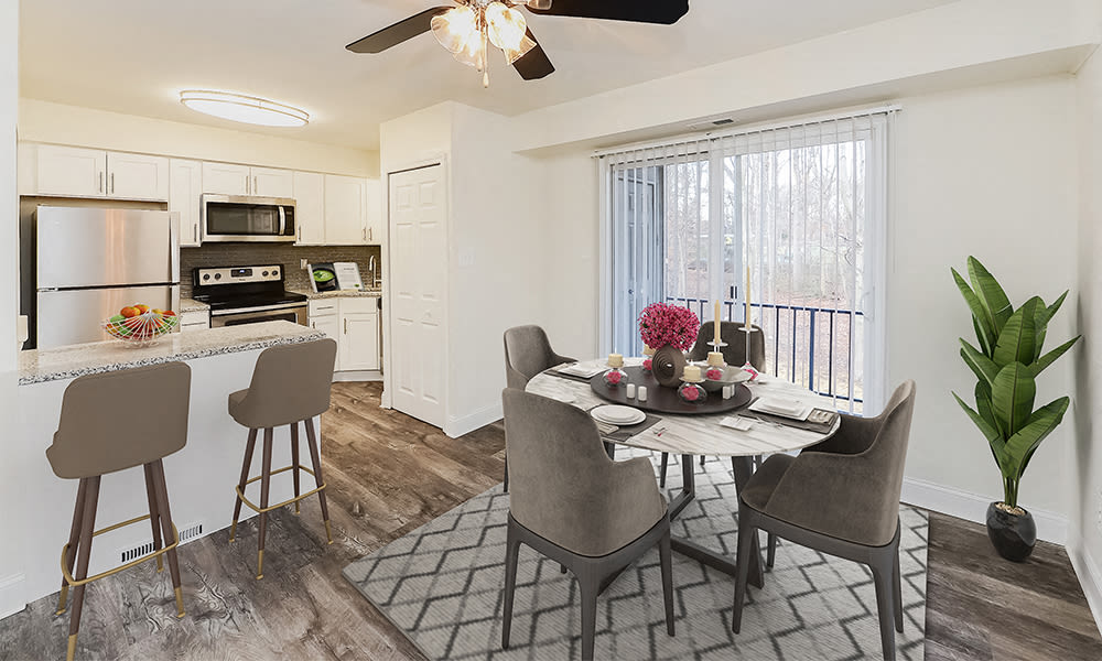 a kitchen and dining room with a table and chairs