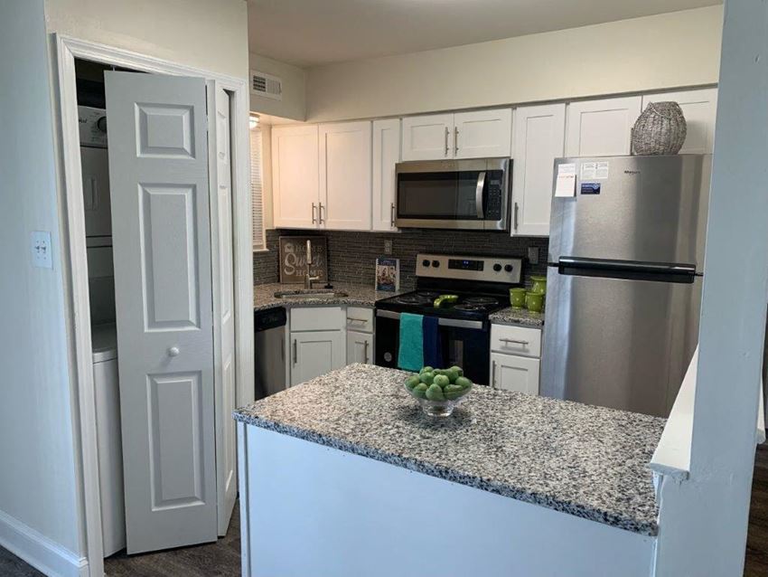 a kitchen with stainless steel appliances and a granite counter top