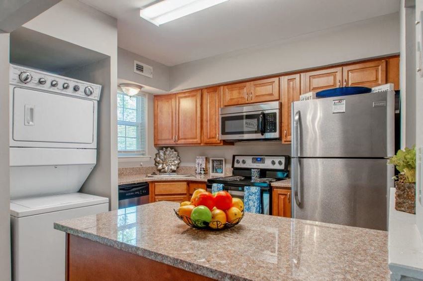 a kitchen with stainless steel appliances and a bowl of fruit