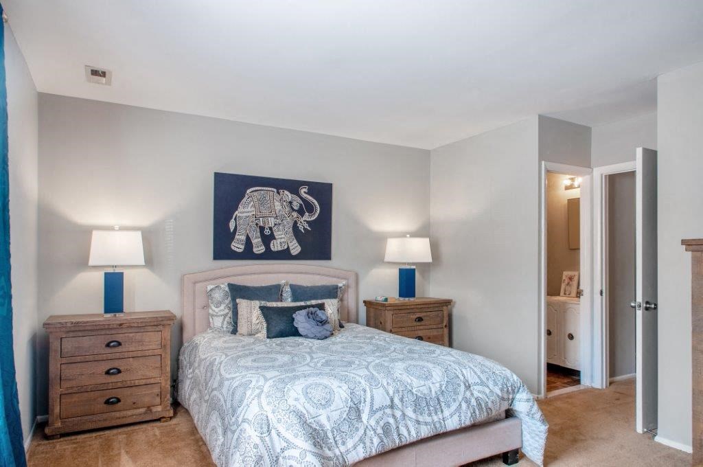 a bedroom with a bed and a painting of an elephant