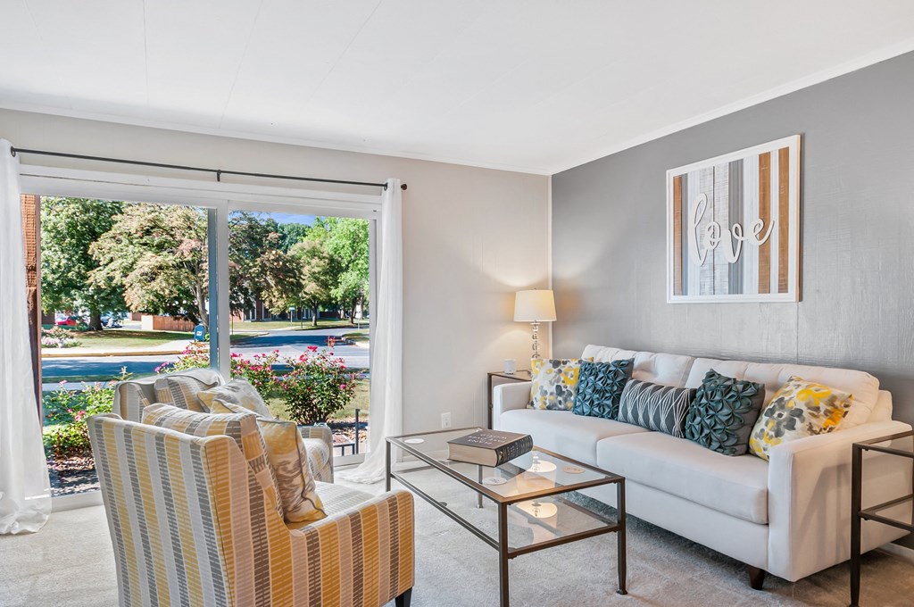 a living room with a couch and a glass coffee table