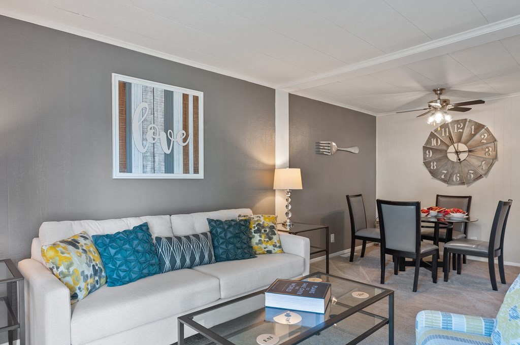 a living room and dining room with a couch and a table