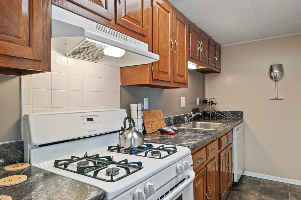 a kitchen with a stove top oven and a sink