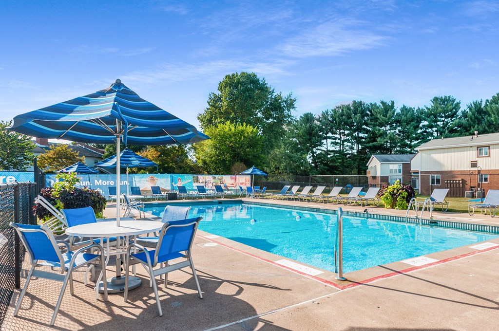 our apartments have a resort style pool with chairs and umbrellas