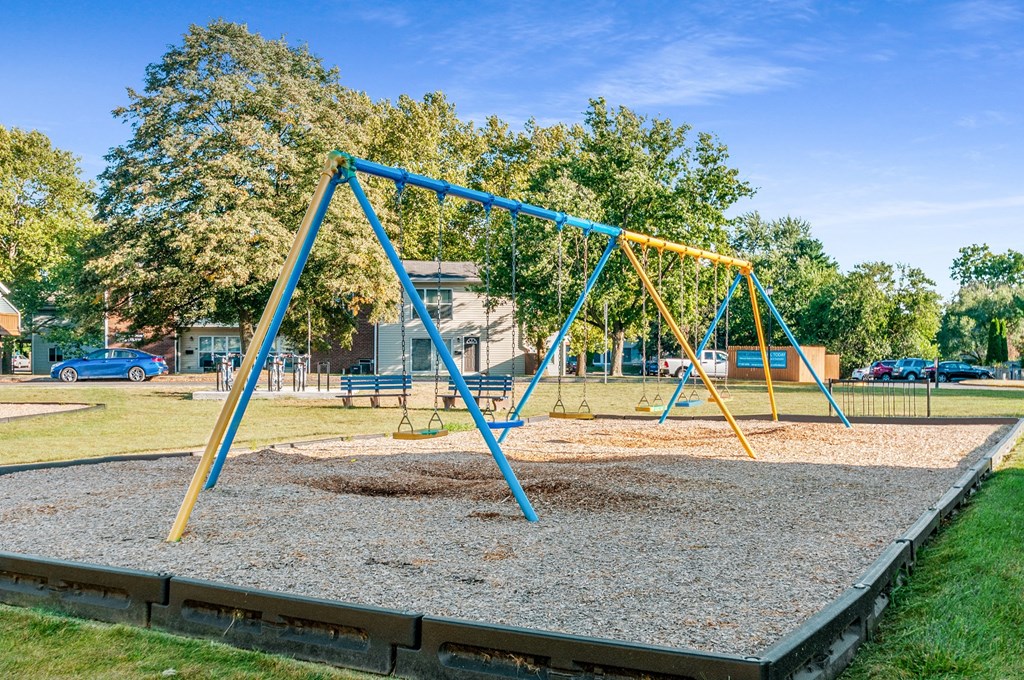 a swing set in a playground on a sunny day