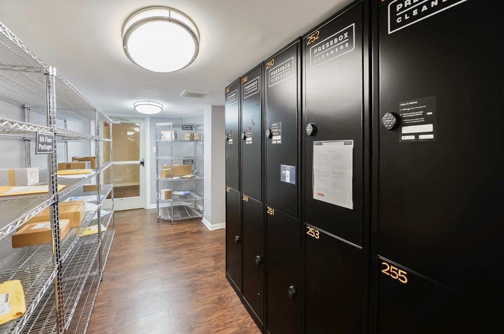 a storage room with black lockers and a walk in closet