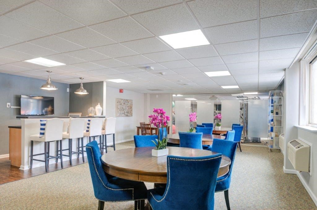 a conference room with blue chairs and a wooden table