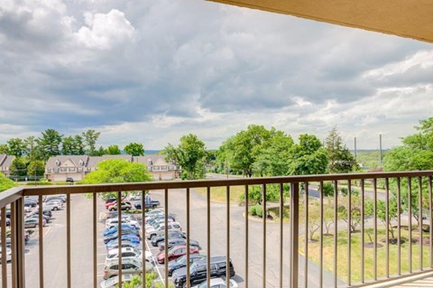 a balcony with a view of a parking lot