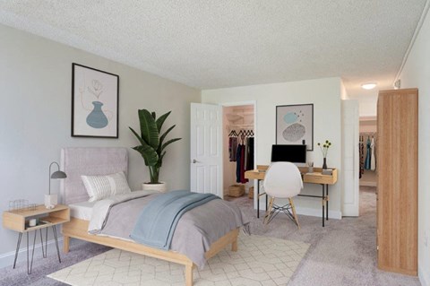 a bedroom with a bed and a desk and a closet