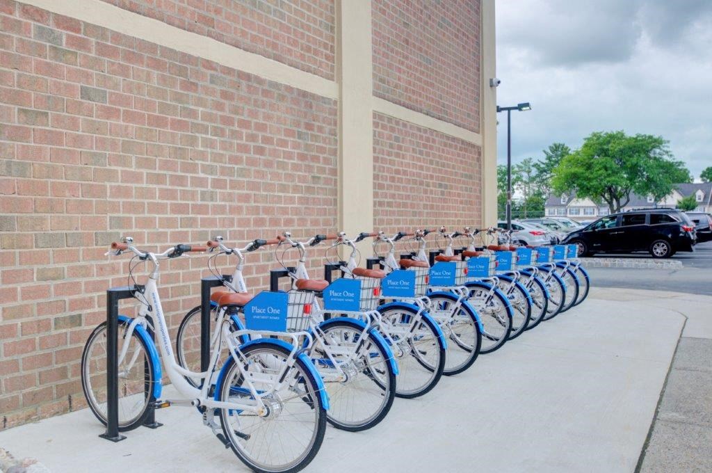 a row of bikes parked in front of a brick building