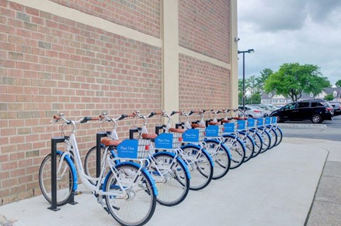 a row of bikes parked in front of a brick building