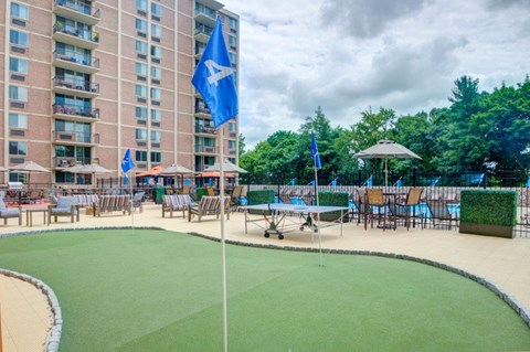 a view of the patio of a hotel with a pool and a flag