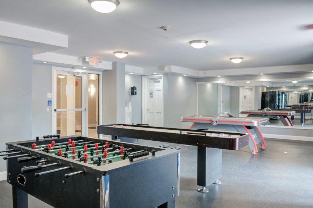a game room with a pool table and ping pong