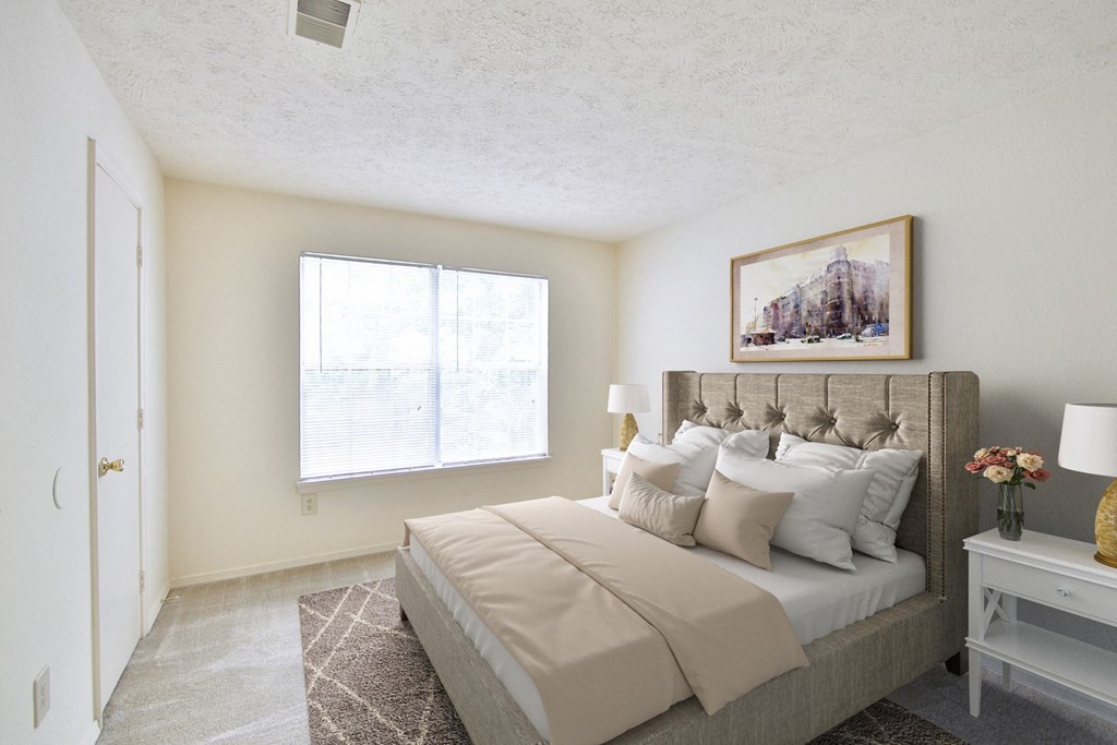 a bedroom with a large bed and a window