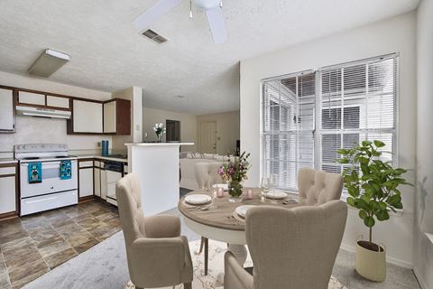 an open kitchen and dining room with a table and chairs