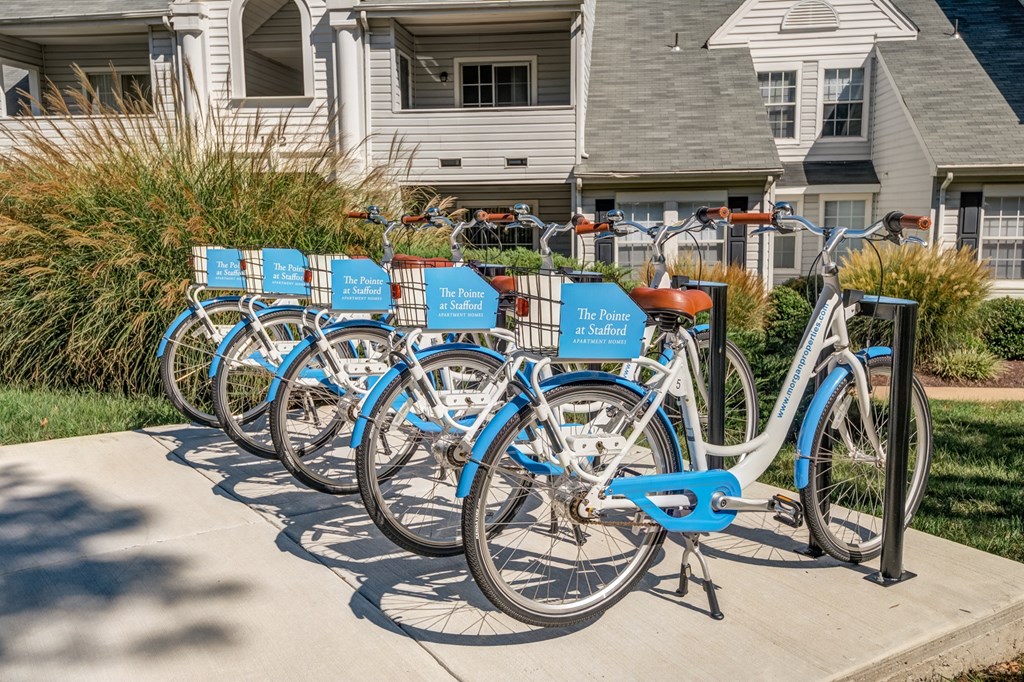 a row of blue bikes parked in front of a house