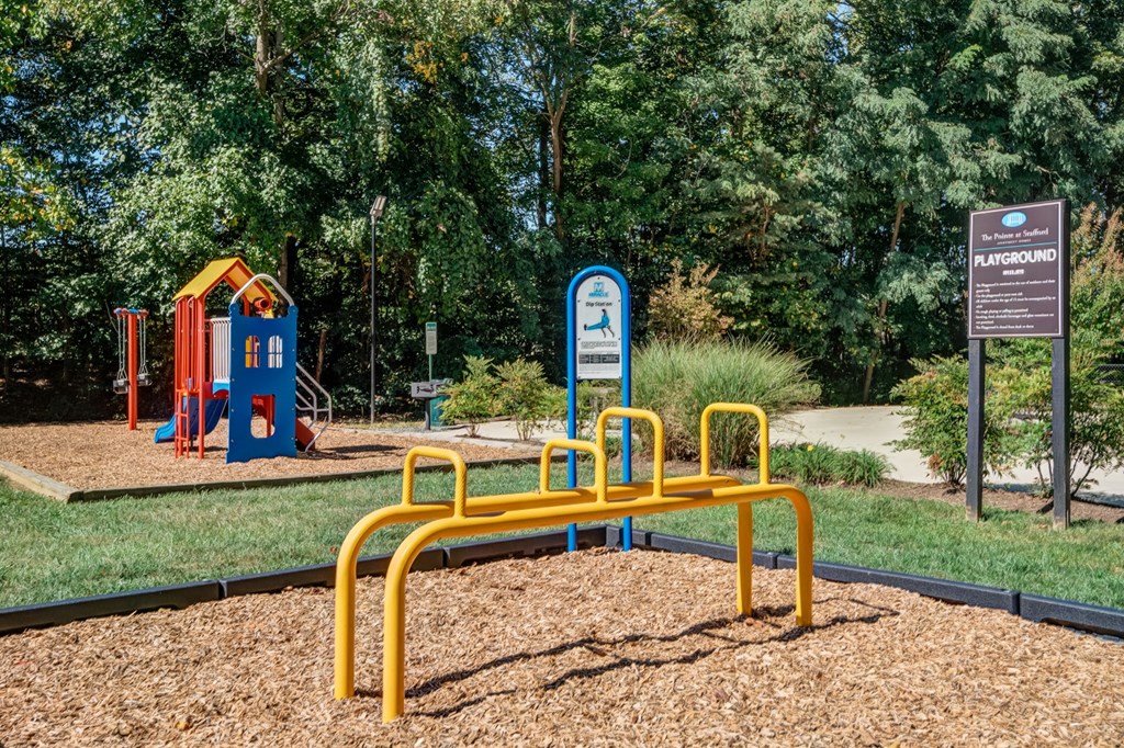 a playground with a yellow bench and childrens playground equipment