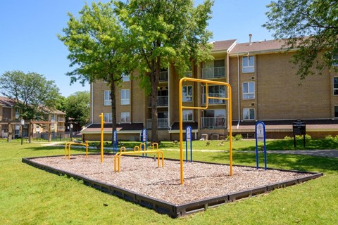a playground in front of an apartment building