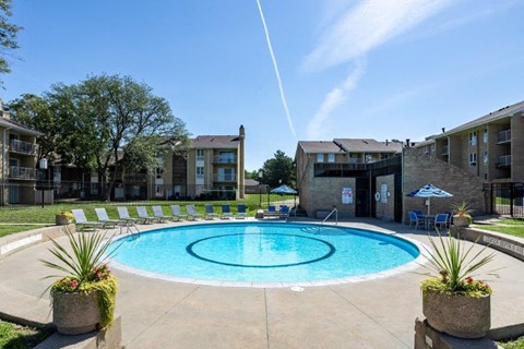 a large swimming pool in front of an apartment building