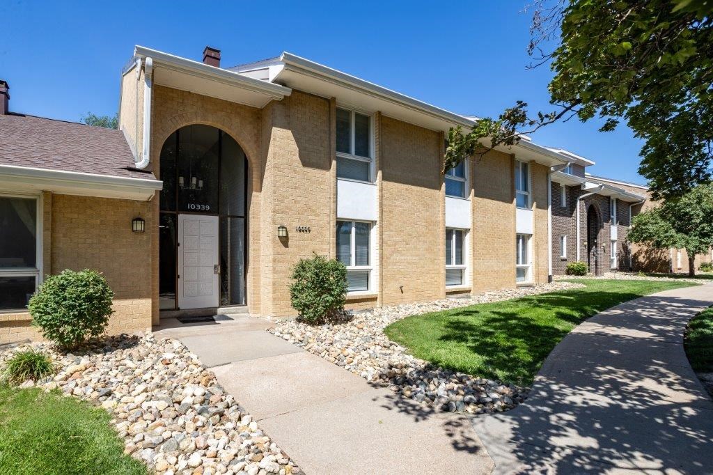 a brick building with a sidewalk in front of it