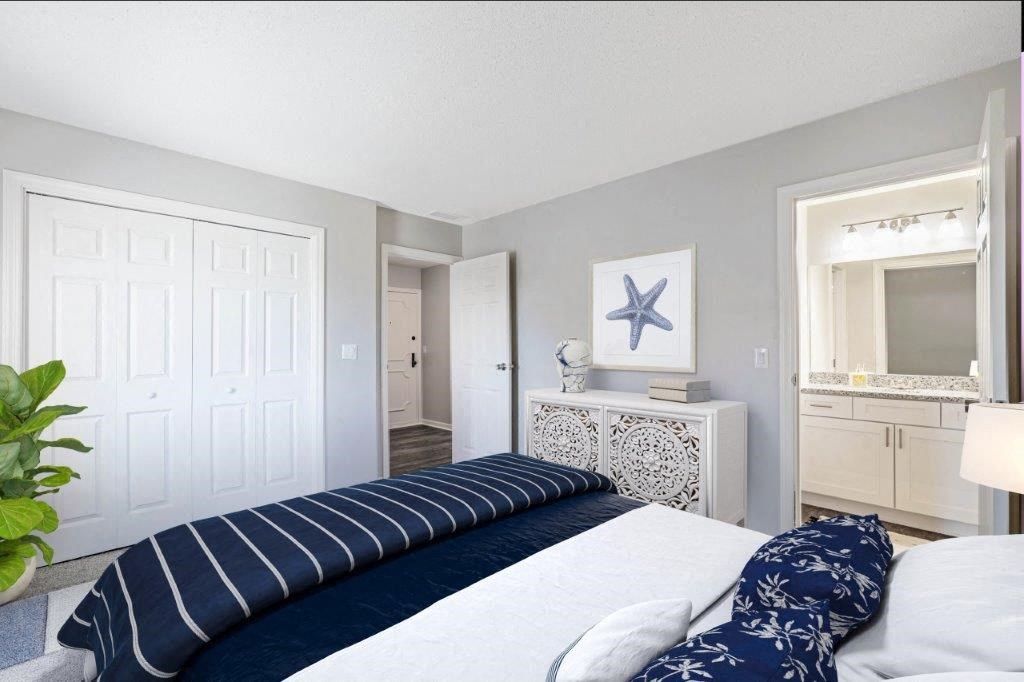 a bedroom with a large bed and a mirror