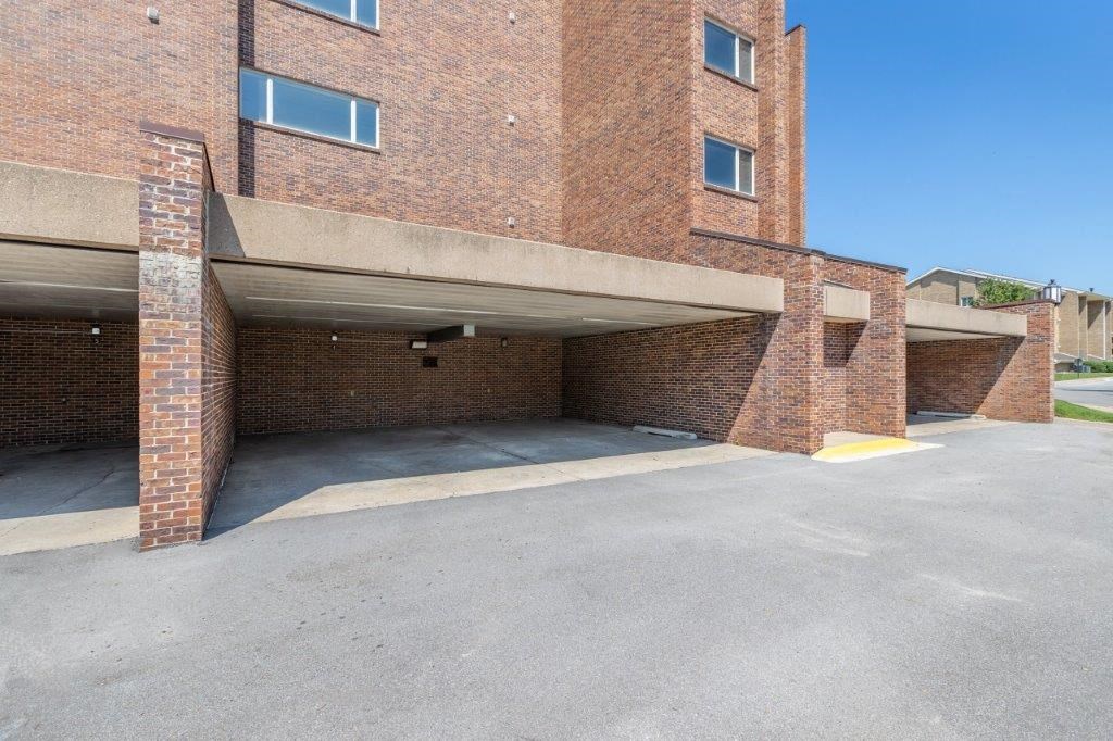 an empty parking lot in front of a brick building