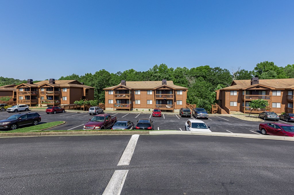 an empty parking lot in front of apartment buildings