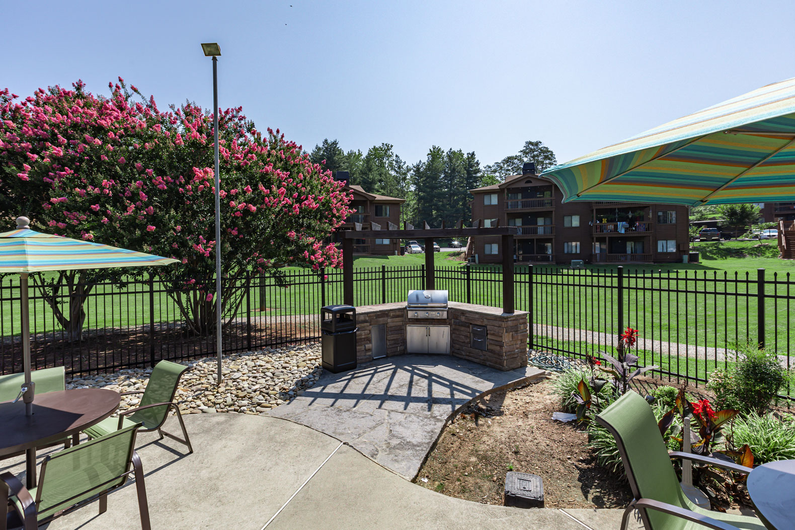 a patio with a fire pit and a table and chairs