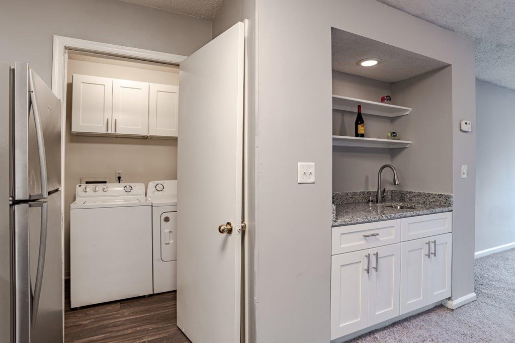 A kitchen with white appliances and cabinets.