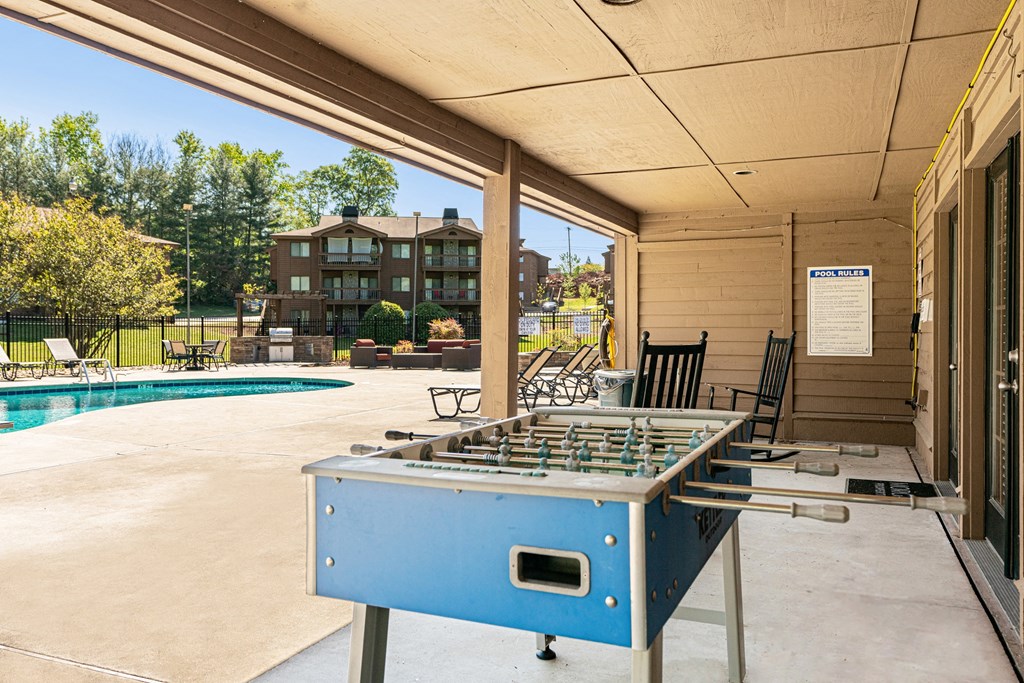 the retreat at thousand oaks clubhouse with shuffleboard table and pool
