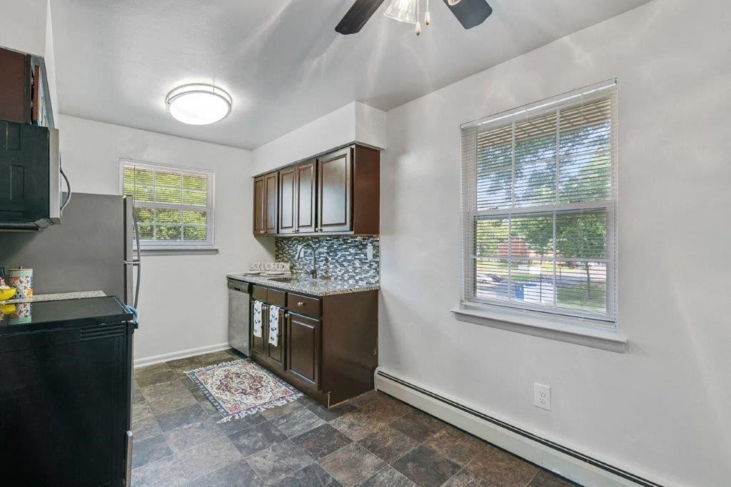 a kitchen with a counter top and a window