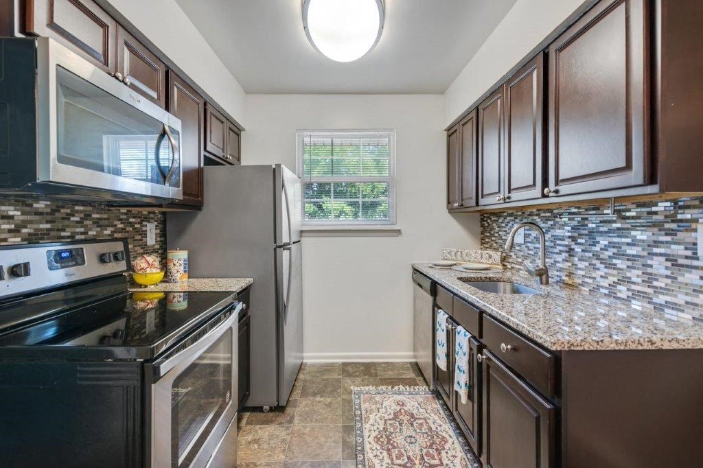 a kitchen with stainless steel appliances and granite counter tops