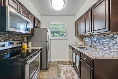 a kitchen with stainless steel appliances and granite counter tops