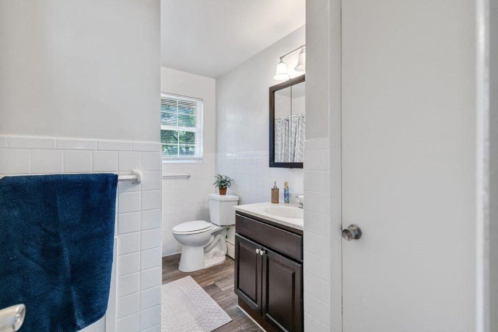 a bathroom with a toilet and a sink and a mirror
