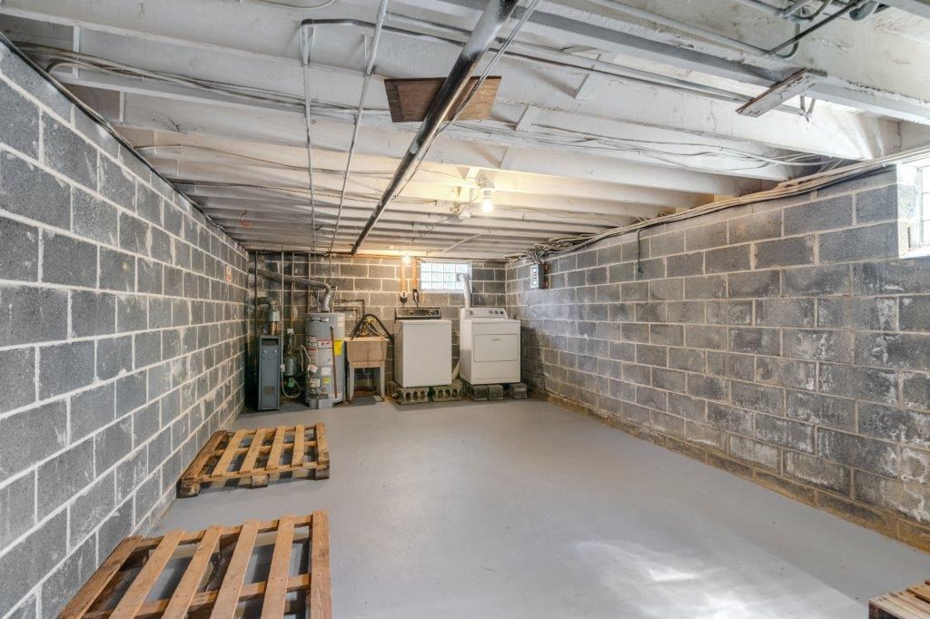 the inside of a basement with wooden benches
