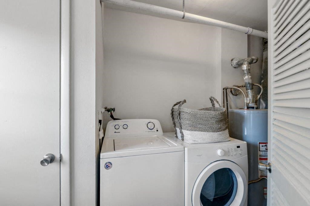 a white washer and dryer in a small laundry room
