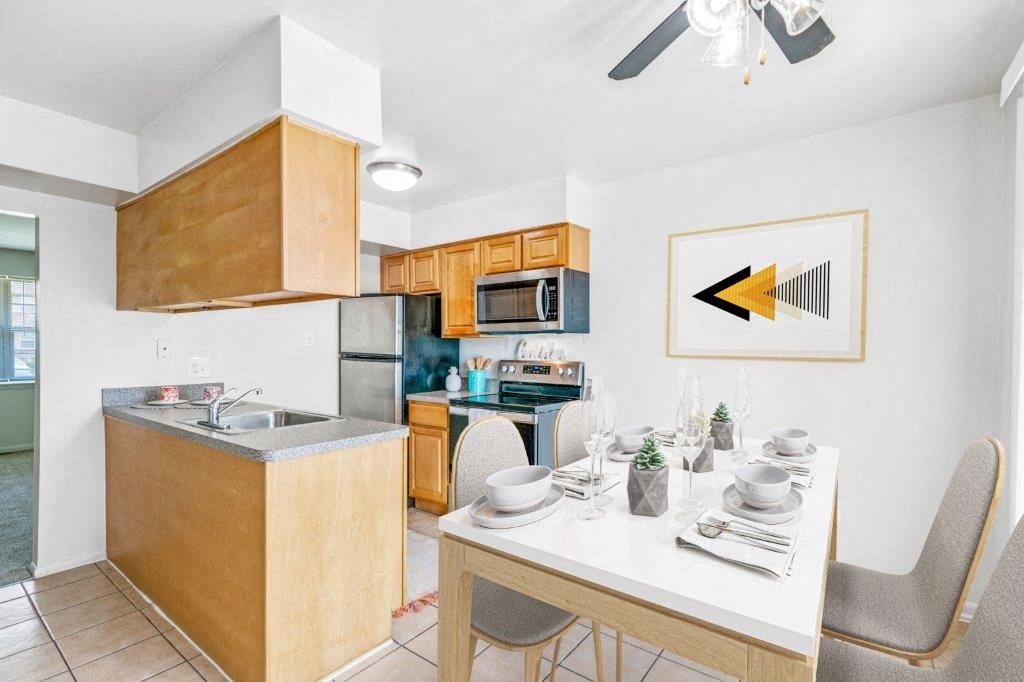 a kitchen and dining room with a table and chairs