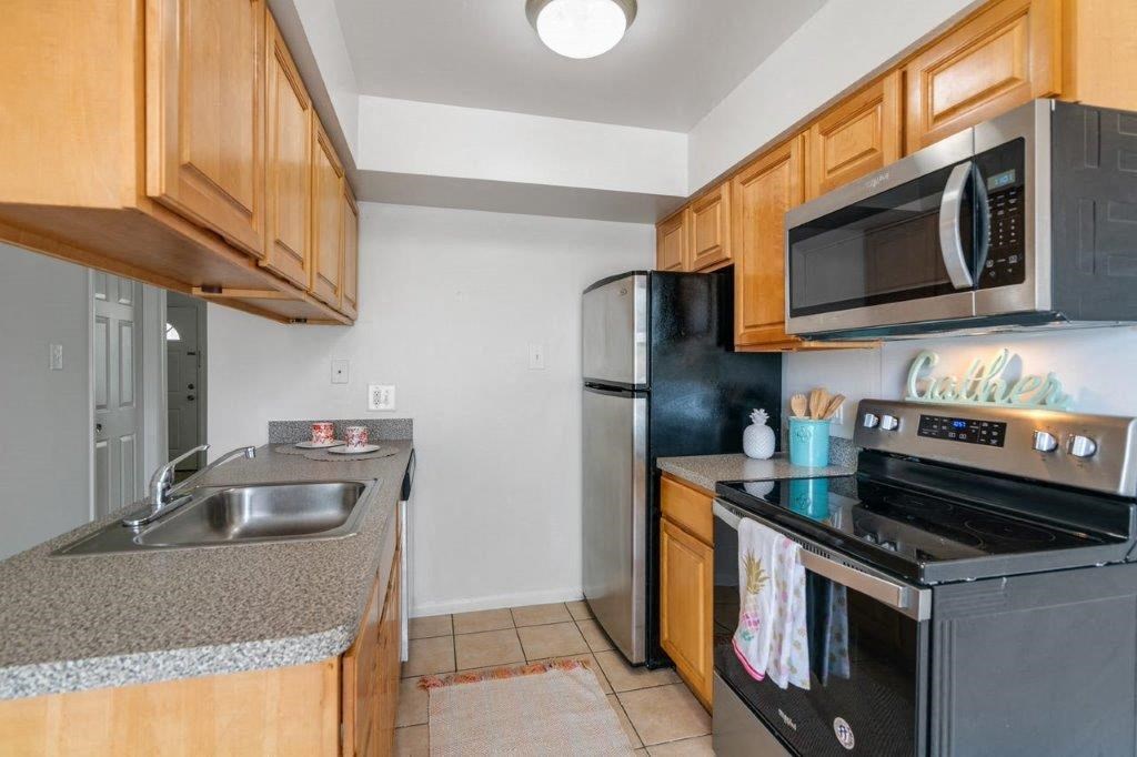 a kitchen with stainless steel appliances and wooden cabinets