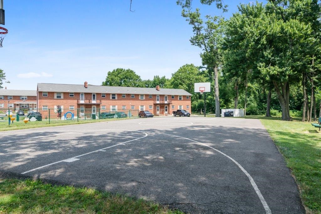 a basketball court in front of a brick building
