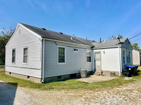 A two-story house with a garage on the side.