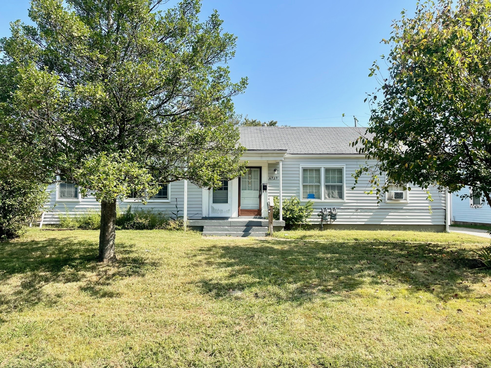A house with a tree in front of it.