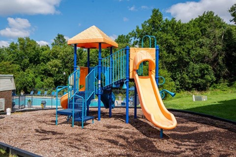 a playground with a slide and a swing set
