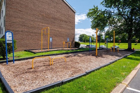 a playground in front of a brick building