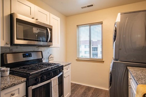 a kitchen with a stove microwave and refrigerator