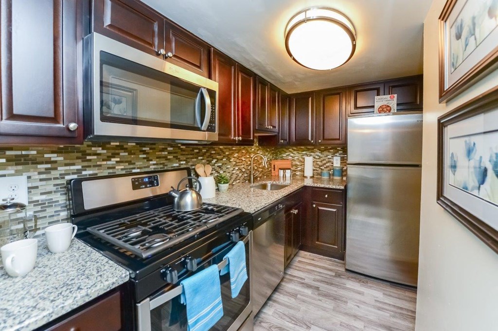 a kitchen with stainless steel appliances and granite counter tops